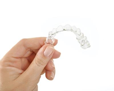 hand holding clear aligners