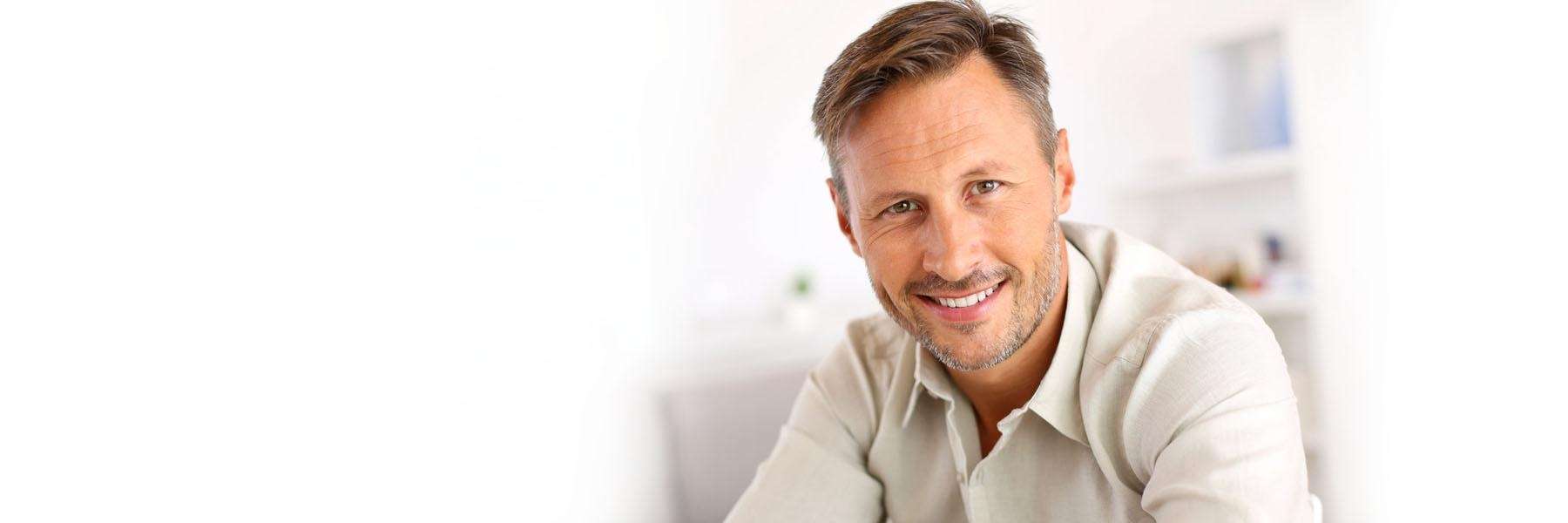 Man showing a bright smile after front tooth implant restoration