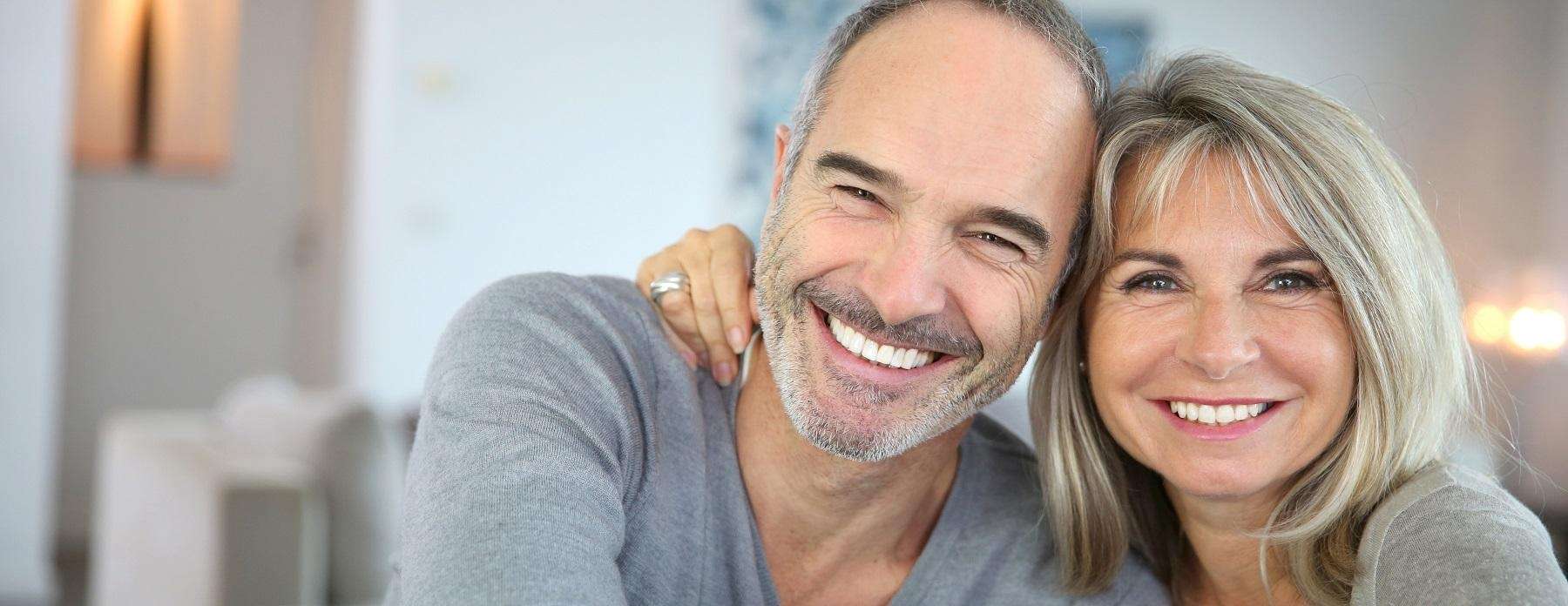 A smiling couple, reflecting positive dental treatment results