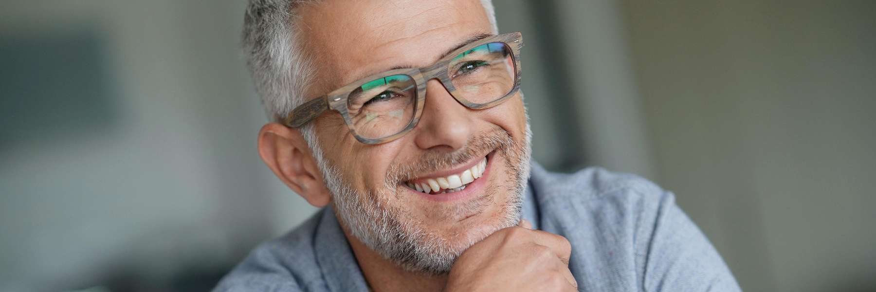 older man with glasses smiling