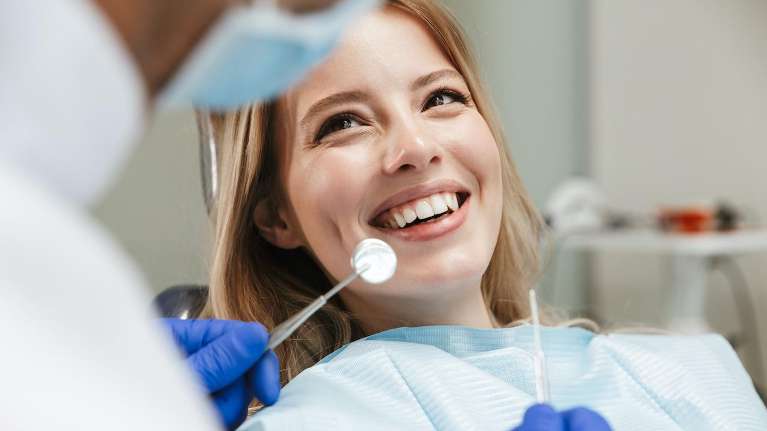 Woman in a dental chair waiting for dental implant procedure