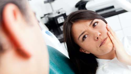 A woman with an urgent tooth pain issue receiving care from a general dentist in El Dorado Hills.