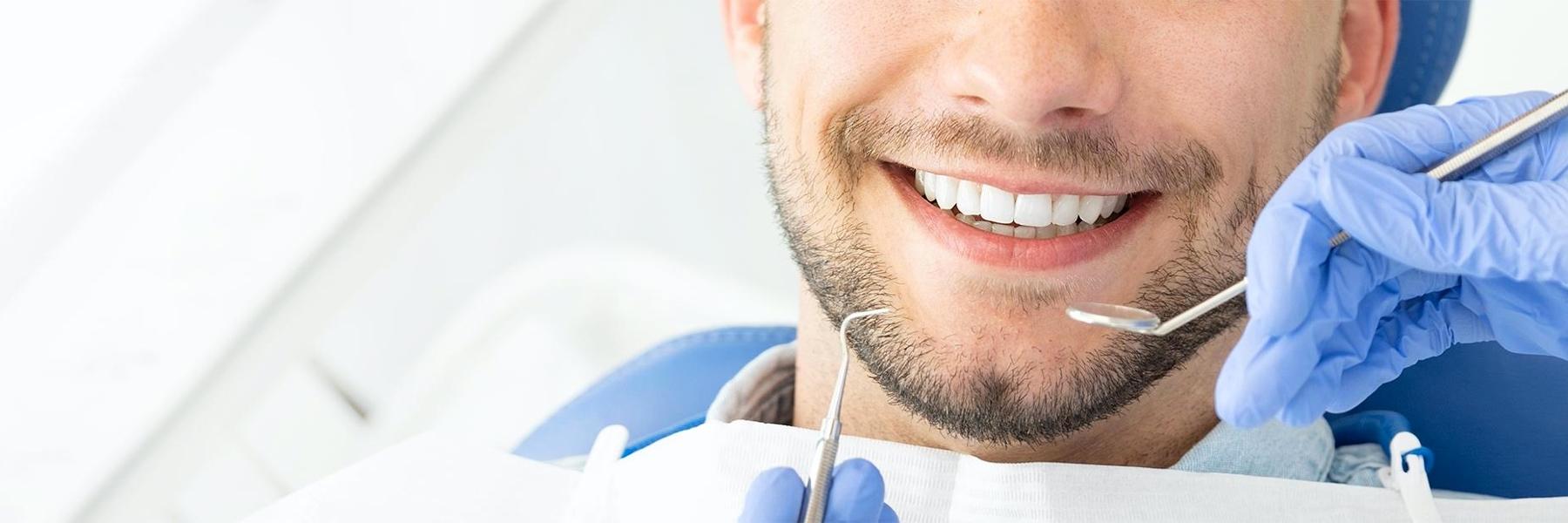 man sitting in dental chair