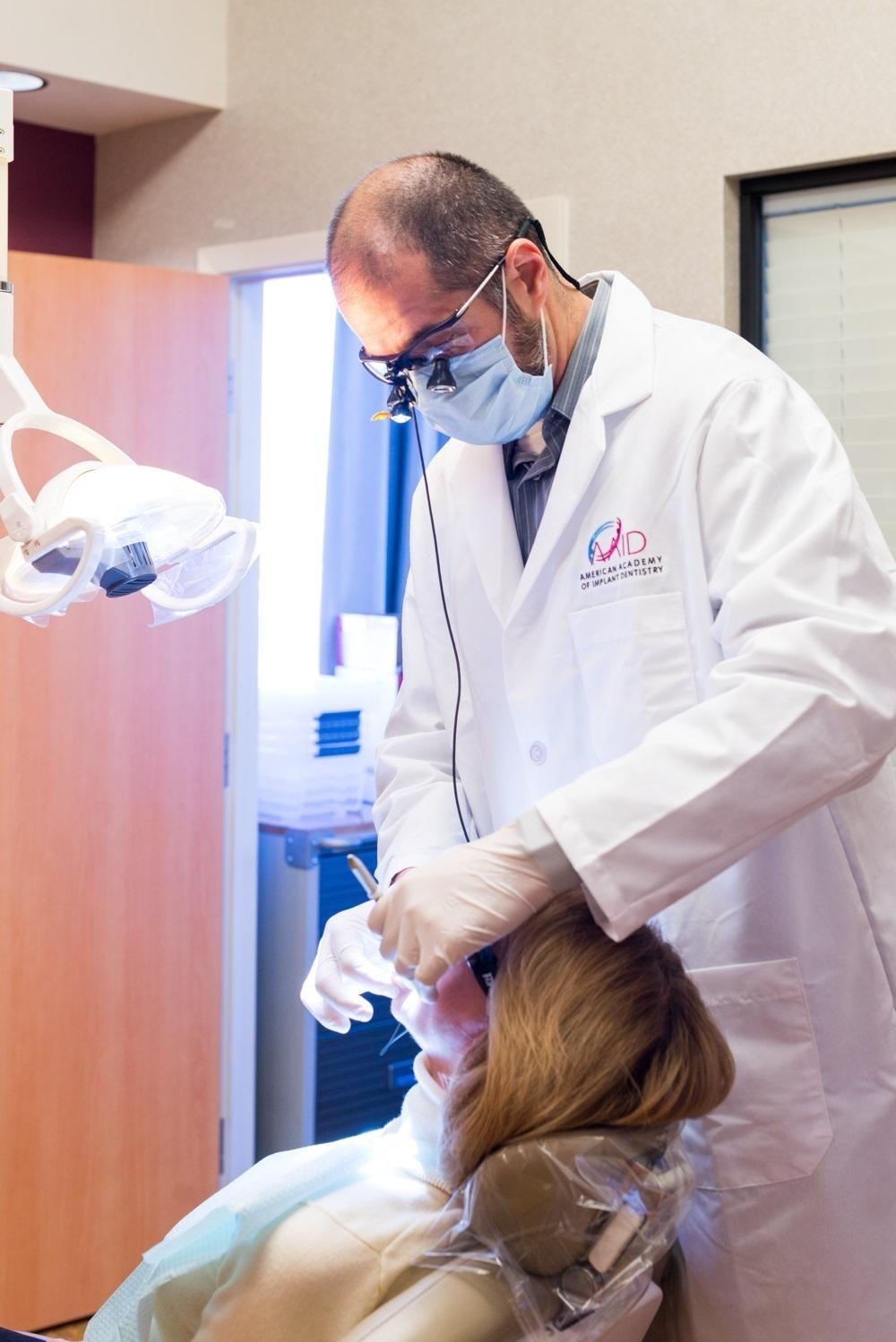 dr. albik working on a patient at el dorado family dental