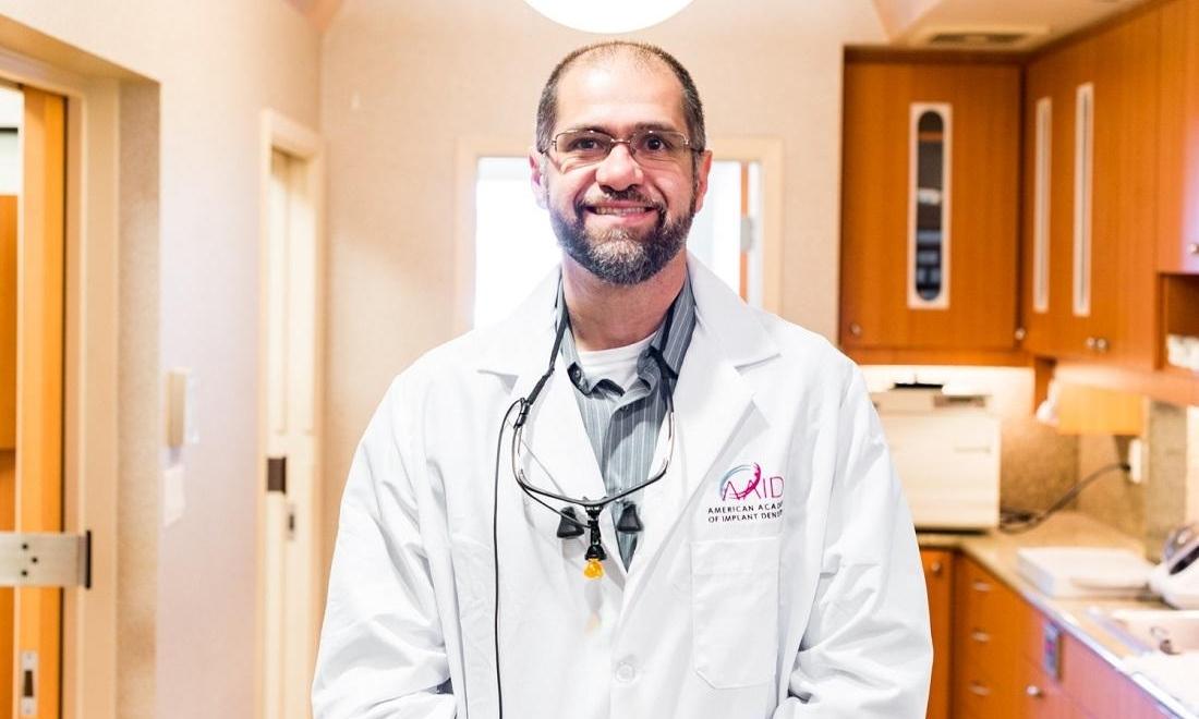 dr. albik in white dentist robe at el dorado family dental
